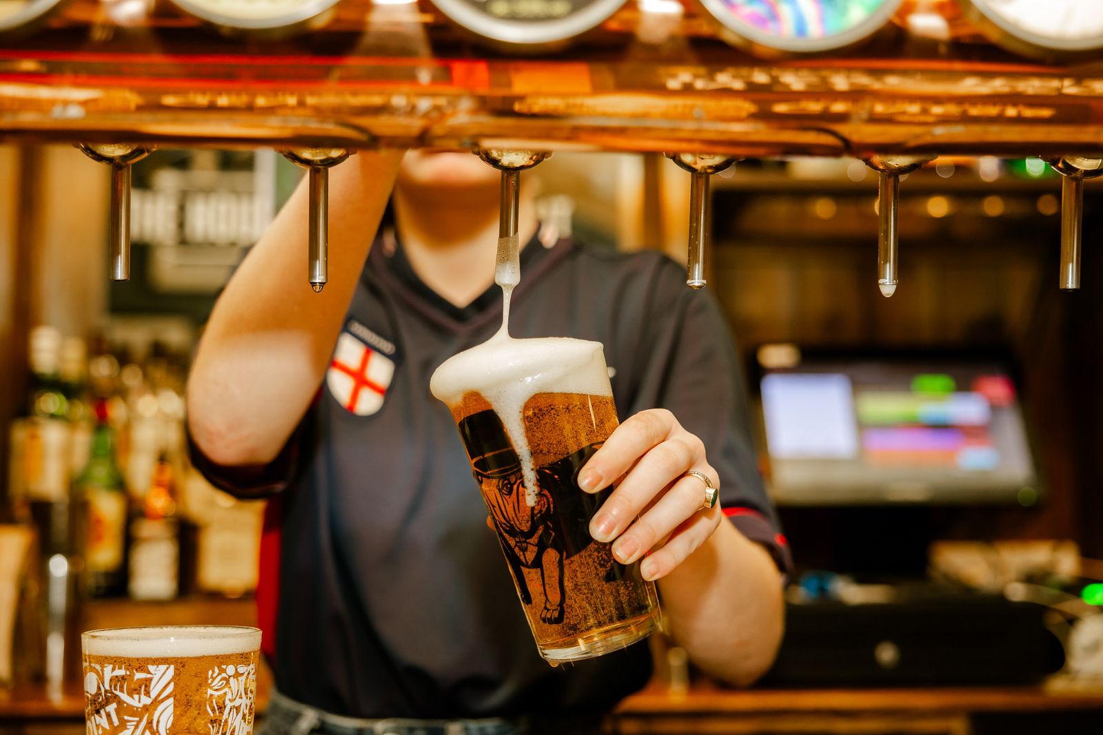 Several shots aligned neatly on a bar. The shots are dark brown in colour. The background is blurred.